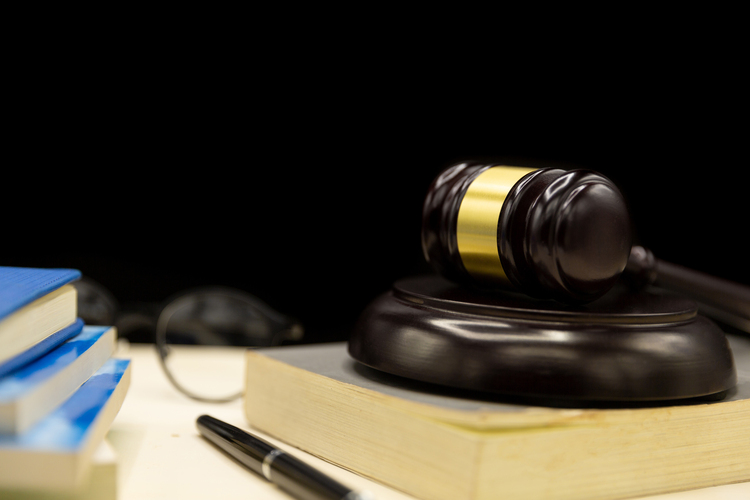 Judge's gavel and notes looking over a car accident lawsuit
